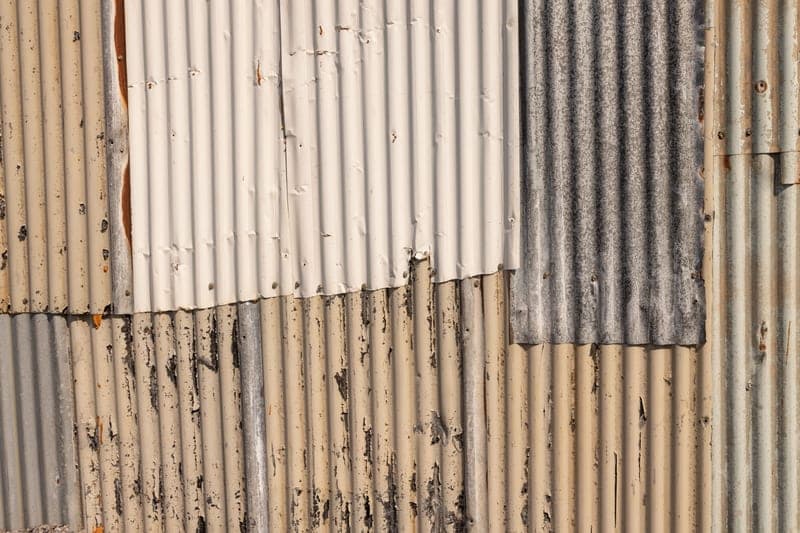 A textured metal build plate surface photographed at an angle